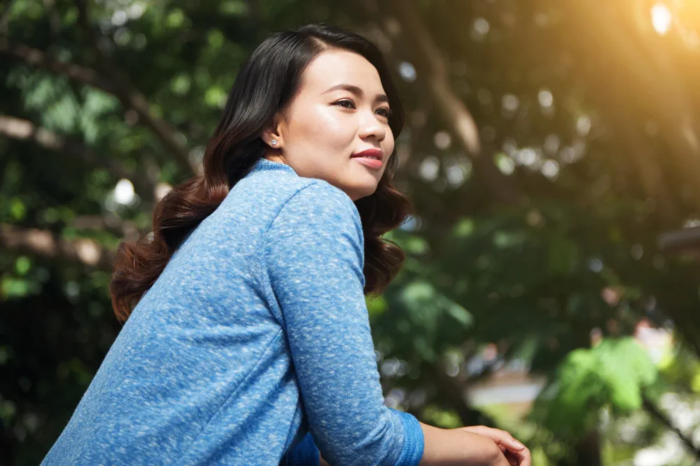 Woman relaxing outdoors during a calm reflective moment