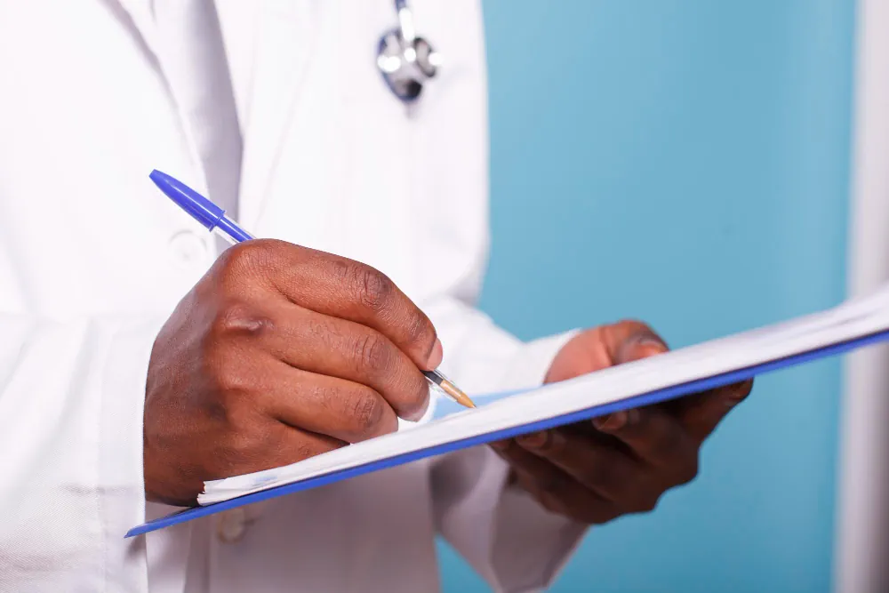 Mental health provider writing individualized care notes on a clipboard