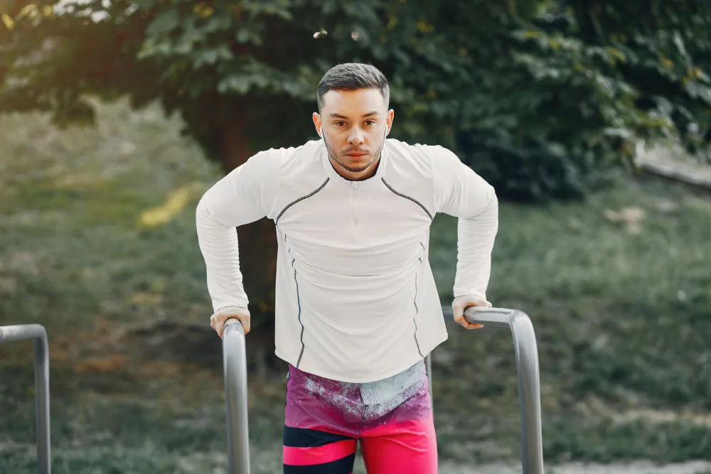 Man exercising outdoors as part of a wellness routine