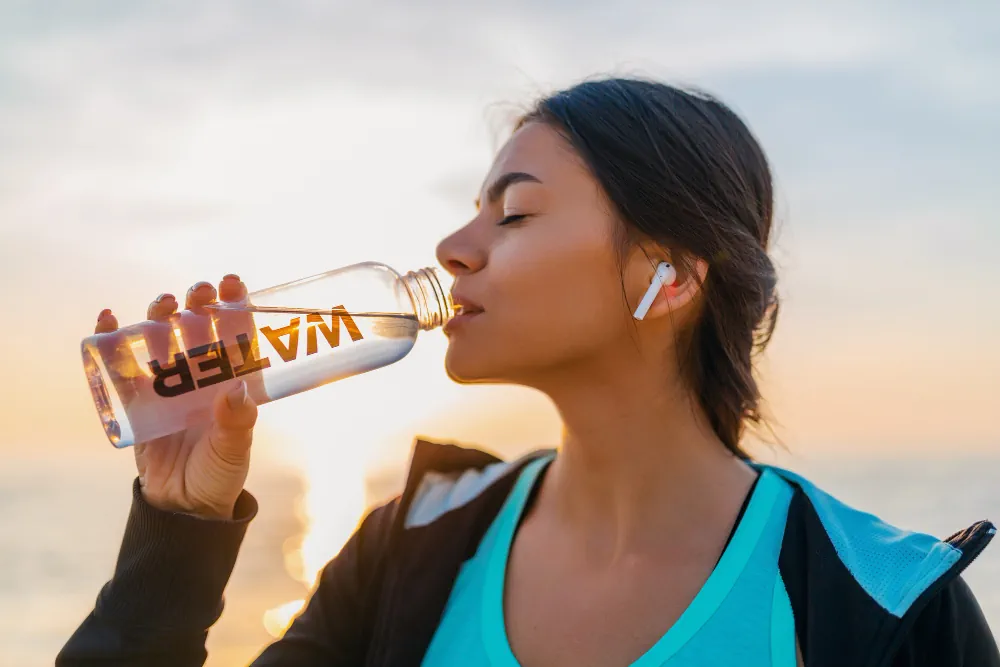 Woman drinking water during a wellness routine