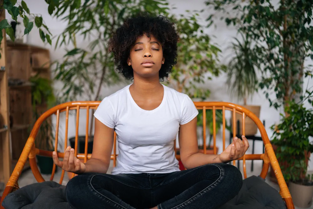 Woman meditating in a calm outdoor setting